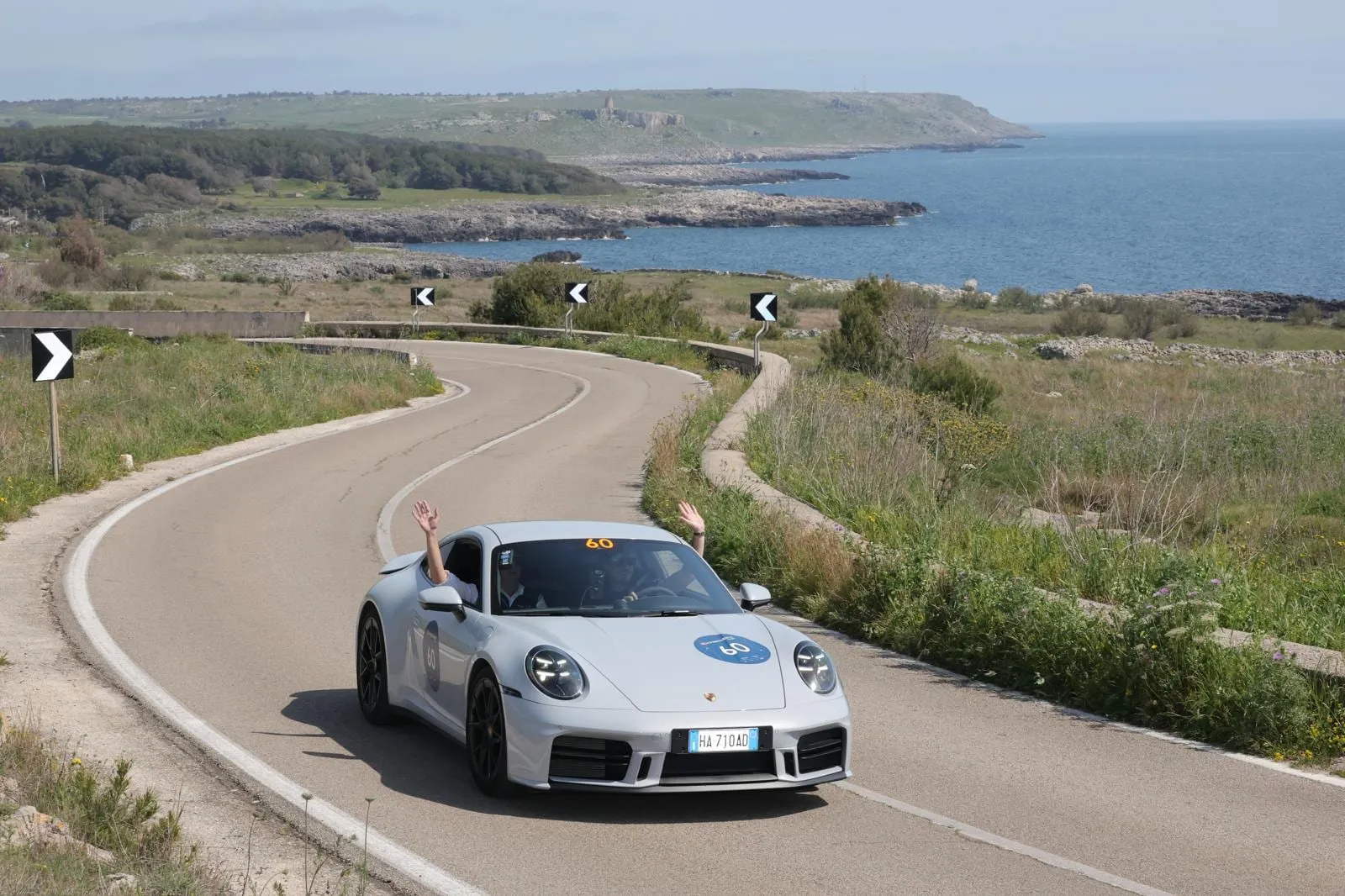 Car 60, a silver 2025 Porsche 911, on a coastal road above the sea in Puglia